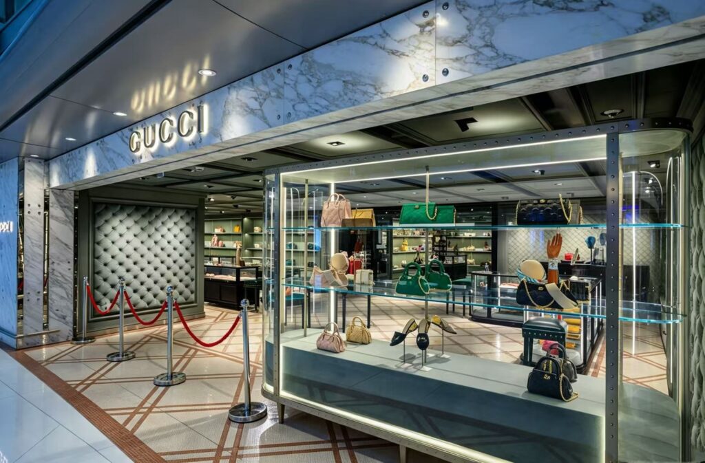 Luxury Gucci retail storefront with bespoke glass display showcase for handbags and footwear